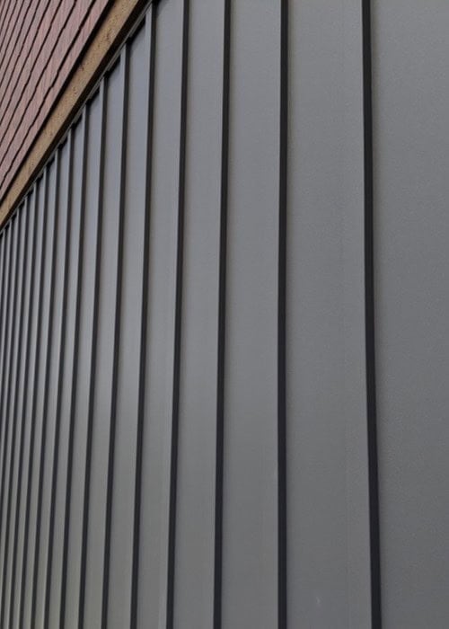 Various custom modules of Zeno-Clad™ cladding displayed in different materials including Zincalume® and Copper